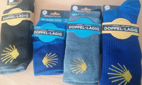 Doppellagige Wandersocken von Wrightsock in Blau, Schwarz und Grau mit Pilgermuschel-Zeichen Doppellagige Wandersocken von Wrightsock in Blau, Schwarz und Grau mit Pilgermuschel-Zeichen